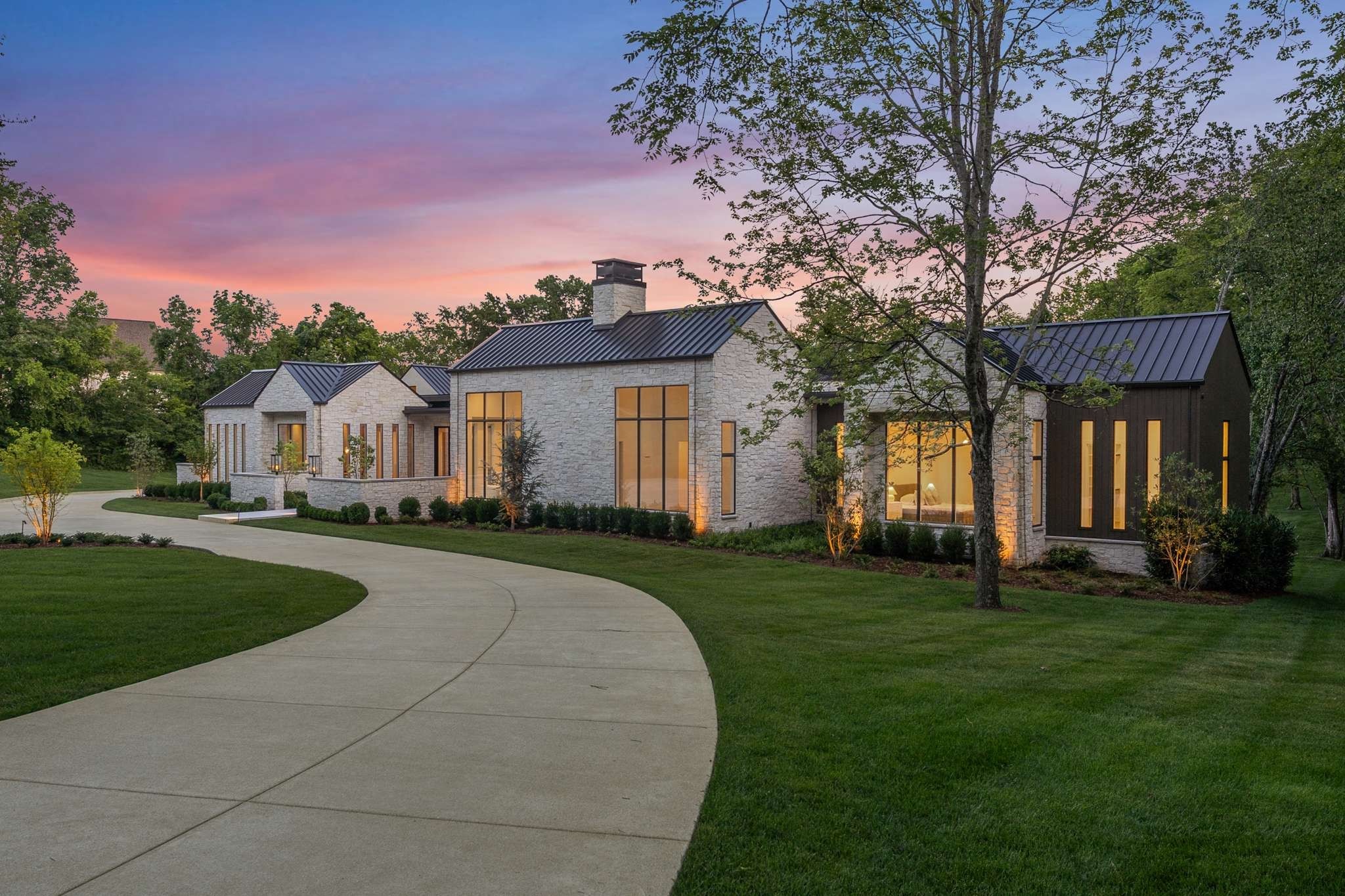 Hillwood luxury estate home in Nashville Tennessee featuring large lot and modern stone exterior