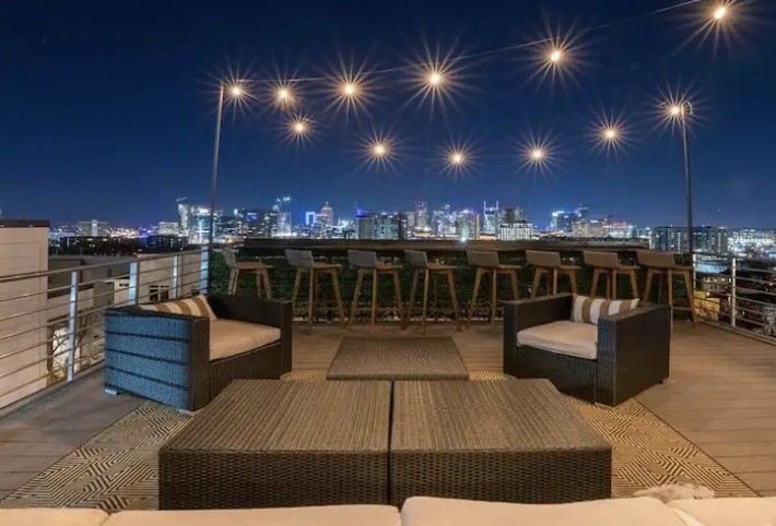 Nashville Airbnb rooftop deck with skyline views representing a 4 bedroom 4 bathroom townhome designed for group travel