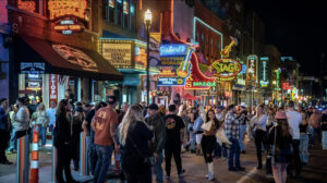 Crowds on Broadway in downtown Nashville at night showing tourism demand that drives Airbnb occupancy and revenue