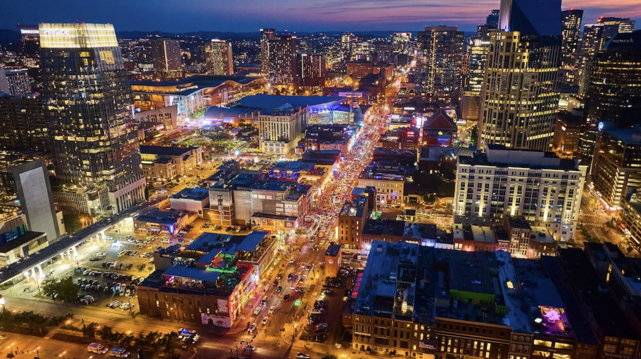 Downtown Nashville skyline at night with Broadway and surrounding areas that drive Airbnb demand and short term rental performance