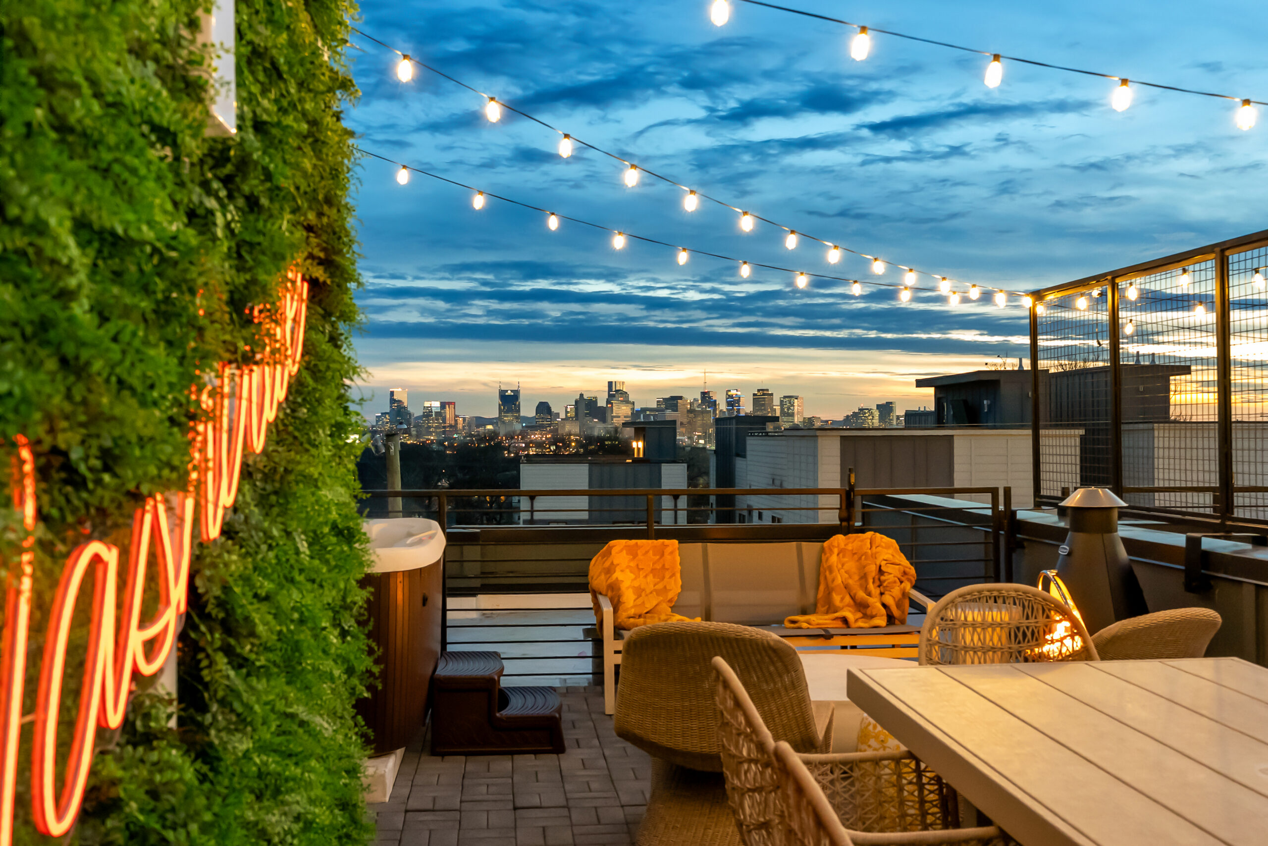 Luxury Nashville Airbnb rooftop deck with seating, string lights, and skyline views designed for group travel and short-term rental performance