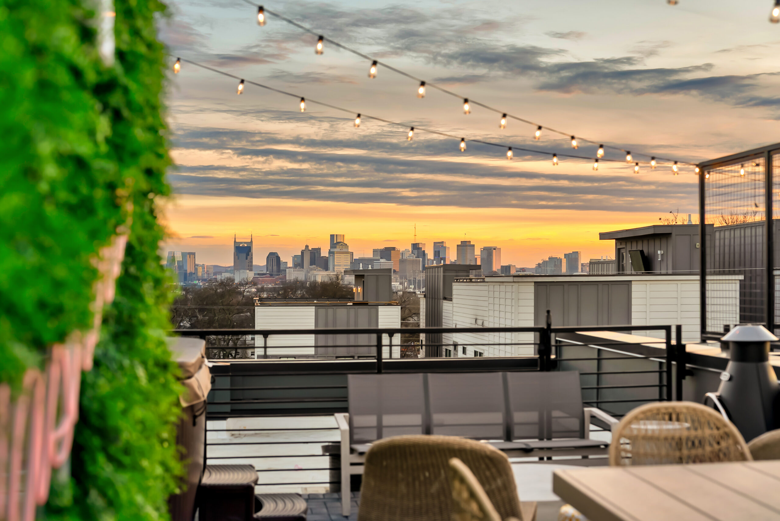 Lucy Nashville Airbnb rooftop view overlooking downtown Nashville skyline at sunset