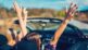 Friends enjoying a summer road trip in a convertible car representing the shift toward drivable vacation destinations in the U.S.