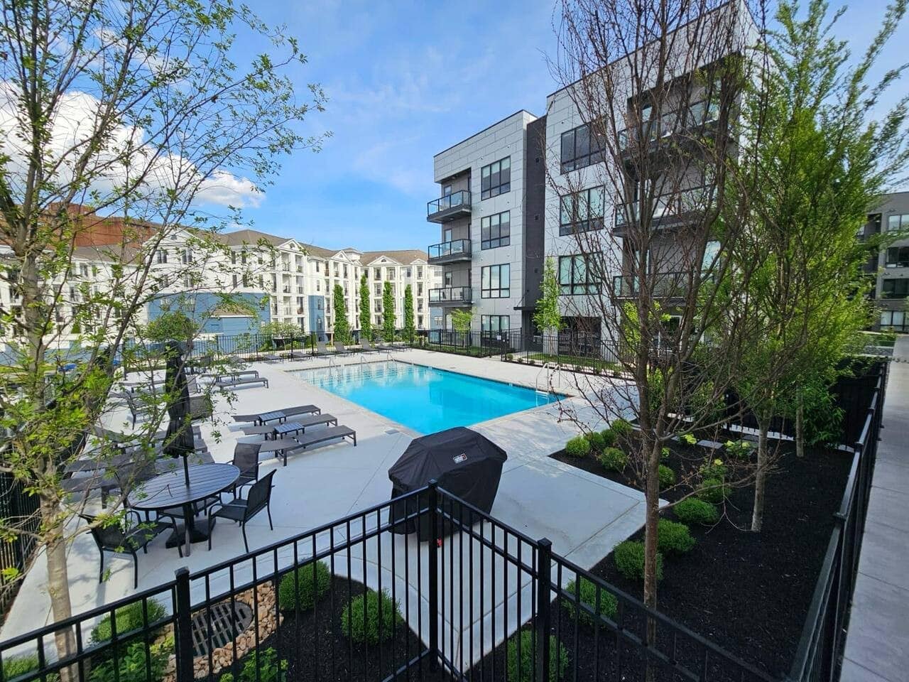 The Odyssey Nashville pool deck amenity with lounge chairs grill and landscaping Midtown NOOSTR Airbnb investment