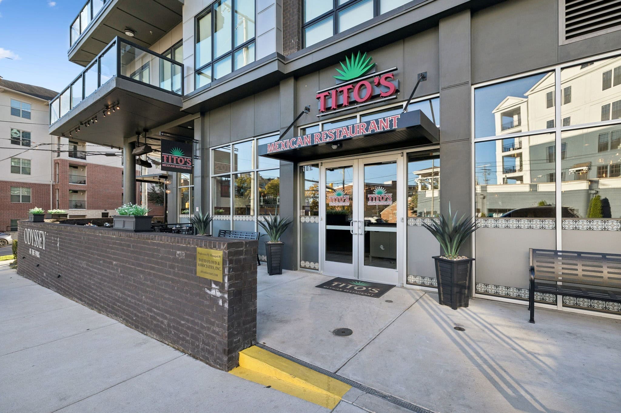 The Odyssey Nashville building exterior at street level with Titos Mexican Restaurant ground-floor retail, Midtown Music Row Airbnb investment