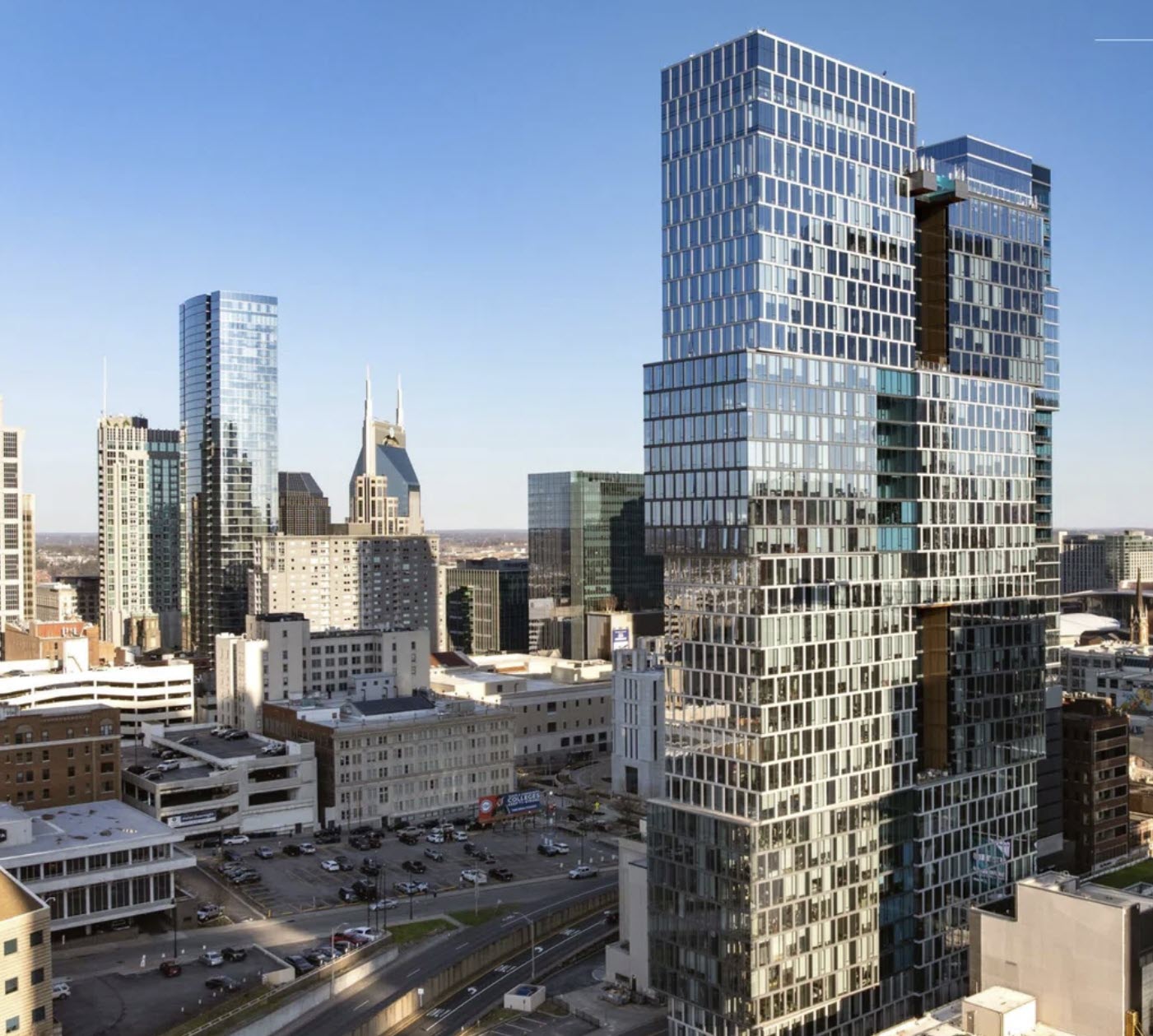 Nashville real estate stories May 3 2026: Alcove apartment tower at 900 Church Street, the 34-story 356-unit downtown high-rise listed for sale through Newmark, shown with the AT&T Building skyline in background