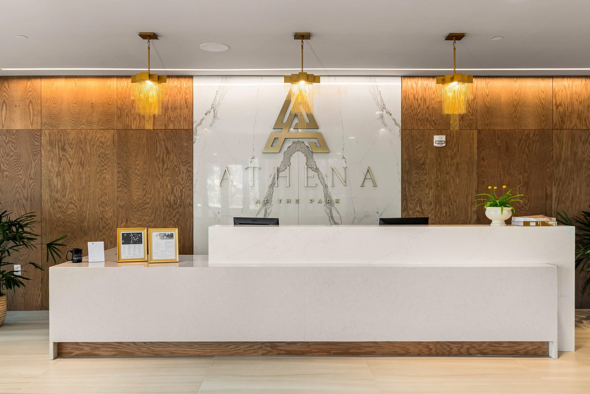 Athena at the Park condominium interior with floor-to-ceiling windows and modern open-floor-plan kitchen