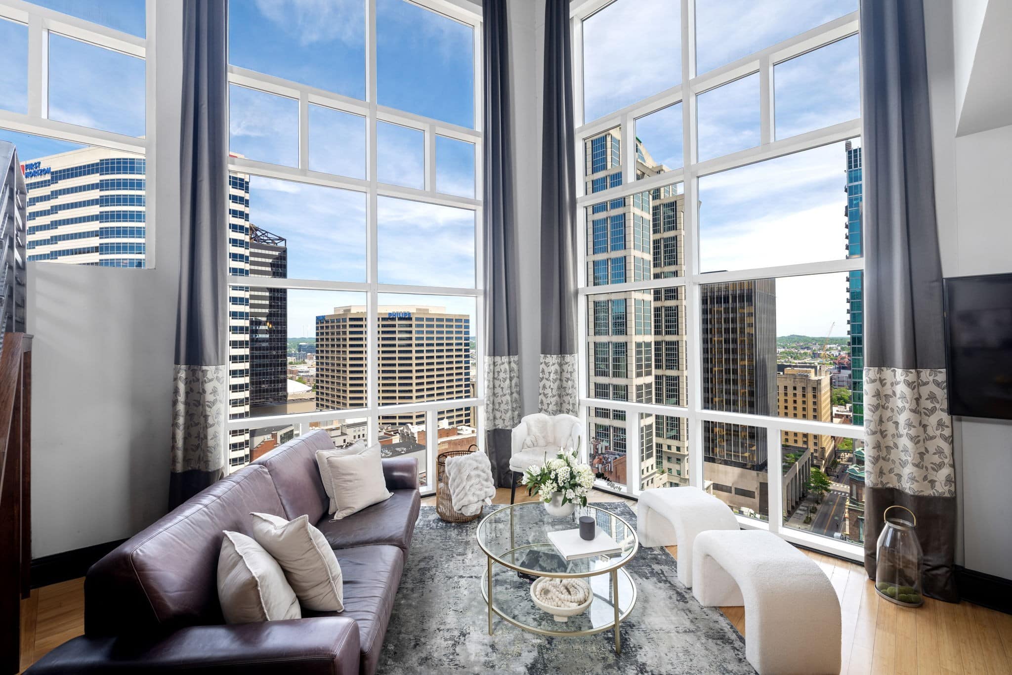 Cumberland Penthouses living room interior with downtown Nashville skyline view