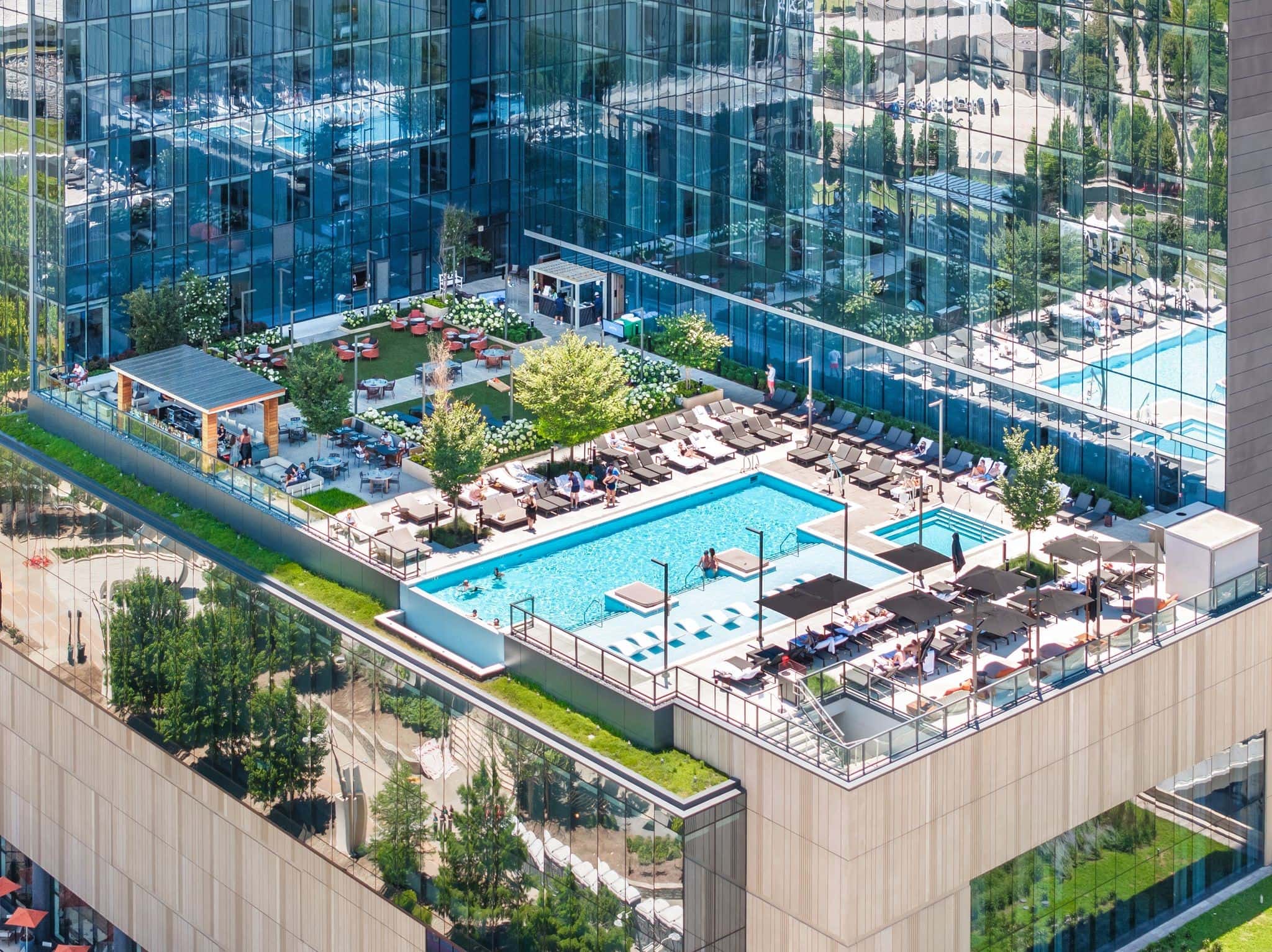 Four Seasons Private Residences pool deck with downtown skyline views from 14th-floor amenity terrace