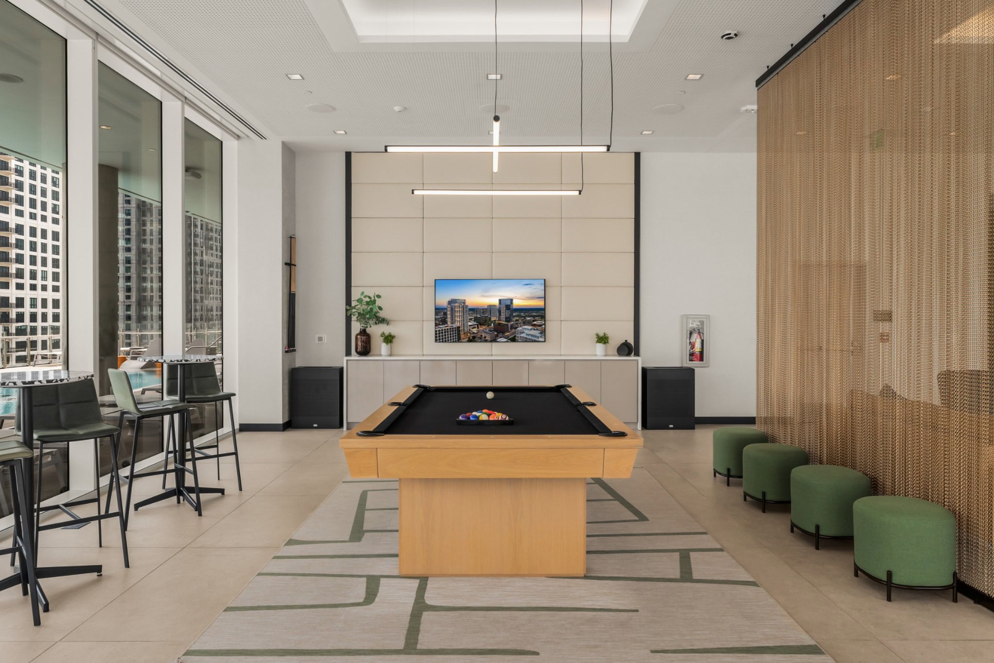 Billiards game room at Prime Nashville with pool table, fluorescent pendants, and woven brick wall
