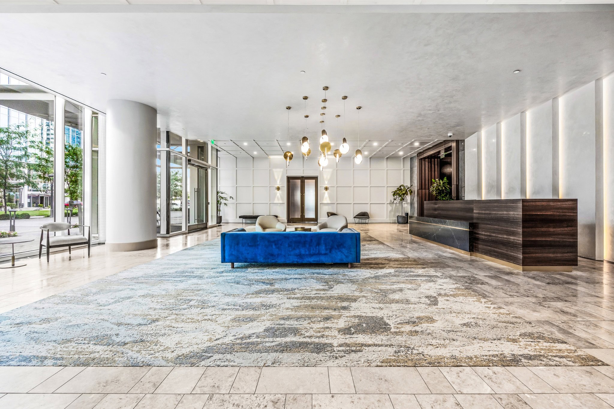 Residences at Broadwest lobby with curated art collection and library lounge