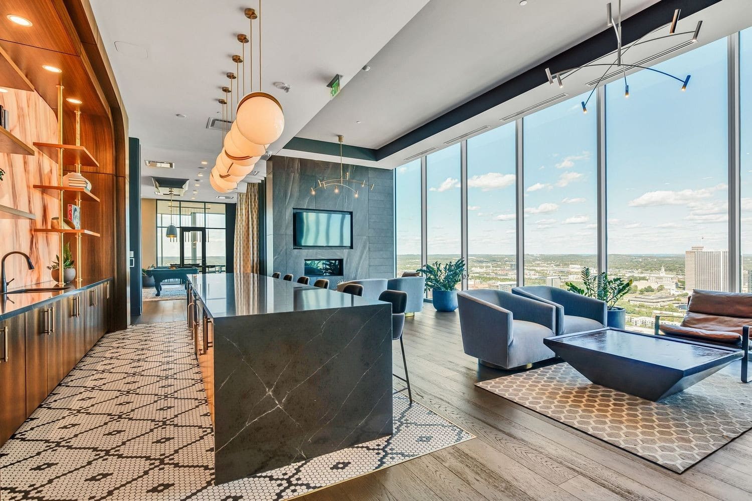 Residences at Broadwest condominium interior with chevron hardwood floors, marble counters, and West End views