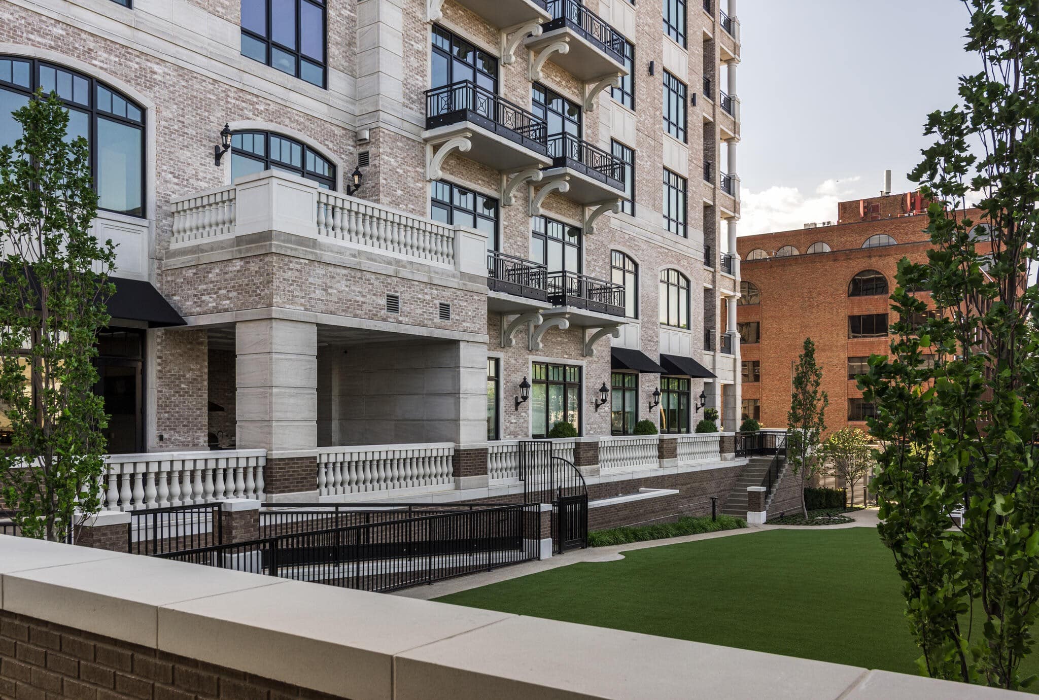 The Manning Belle Meade garden facade with arched windows, juliet balconies, and brick limestone detailing