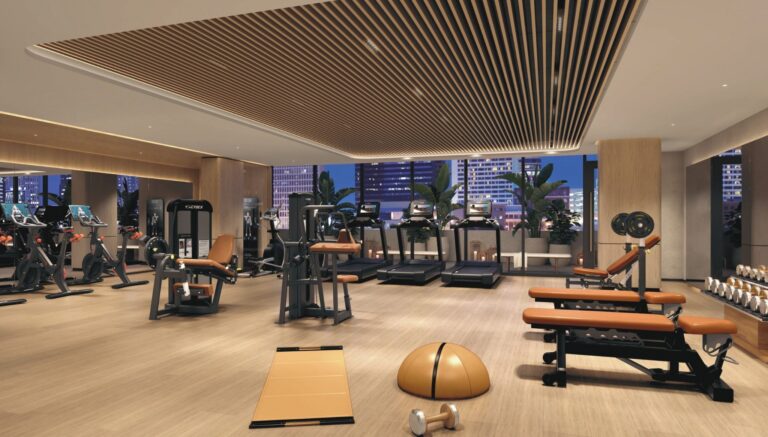 VOCE Hotel and Residences Nashville fitness center with Cybex strength equipment, treadmills, free weights, and panoramic Midtown city views