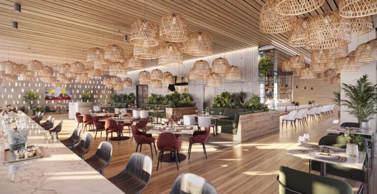 VOCE Hotel and Residences Nashville restaurant interior with rattan pendant lighting, marble bar, and tropical greenery in the Midtown condo hotel