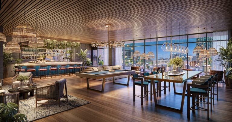 VOCE Hotel and Residences Nashville owner-only club room with billiards table, full bar, dining counter, and Midtown city views, reserved for condo residents
