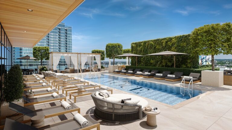 VOCE Hotel and Residences Nashville rooftop pool deck with cabanas, sun loungers, and downtown Nashville skyline views in the Midtown condo hotel