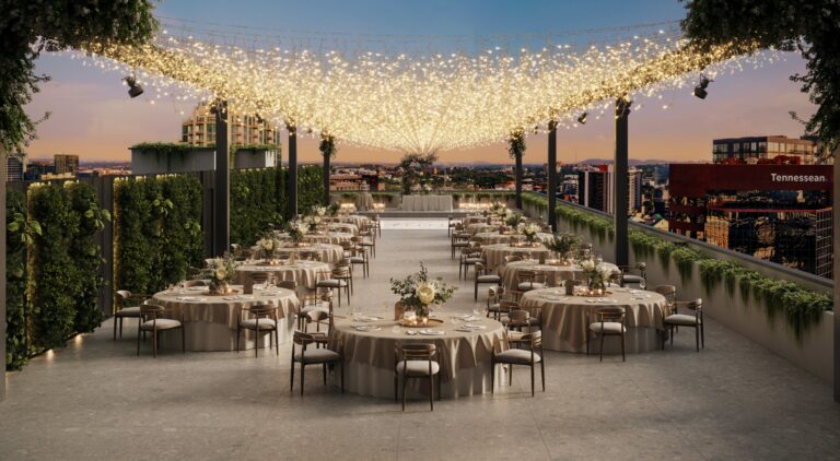 VOCE Hotel and Residences Nashville rooftop event and wedding space with string-light canopy, downtown Nashville skyline backdrop, and Tennessean newspaper building views