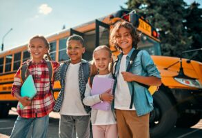 Students with backpacks and a school bus, representing Williamson County Schools attendance zones in Franklin, Tennessee.